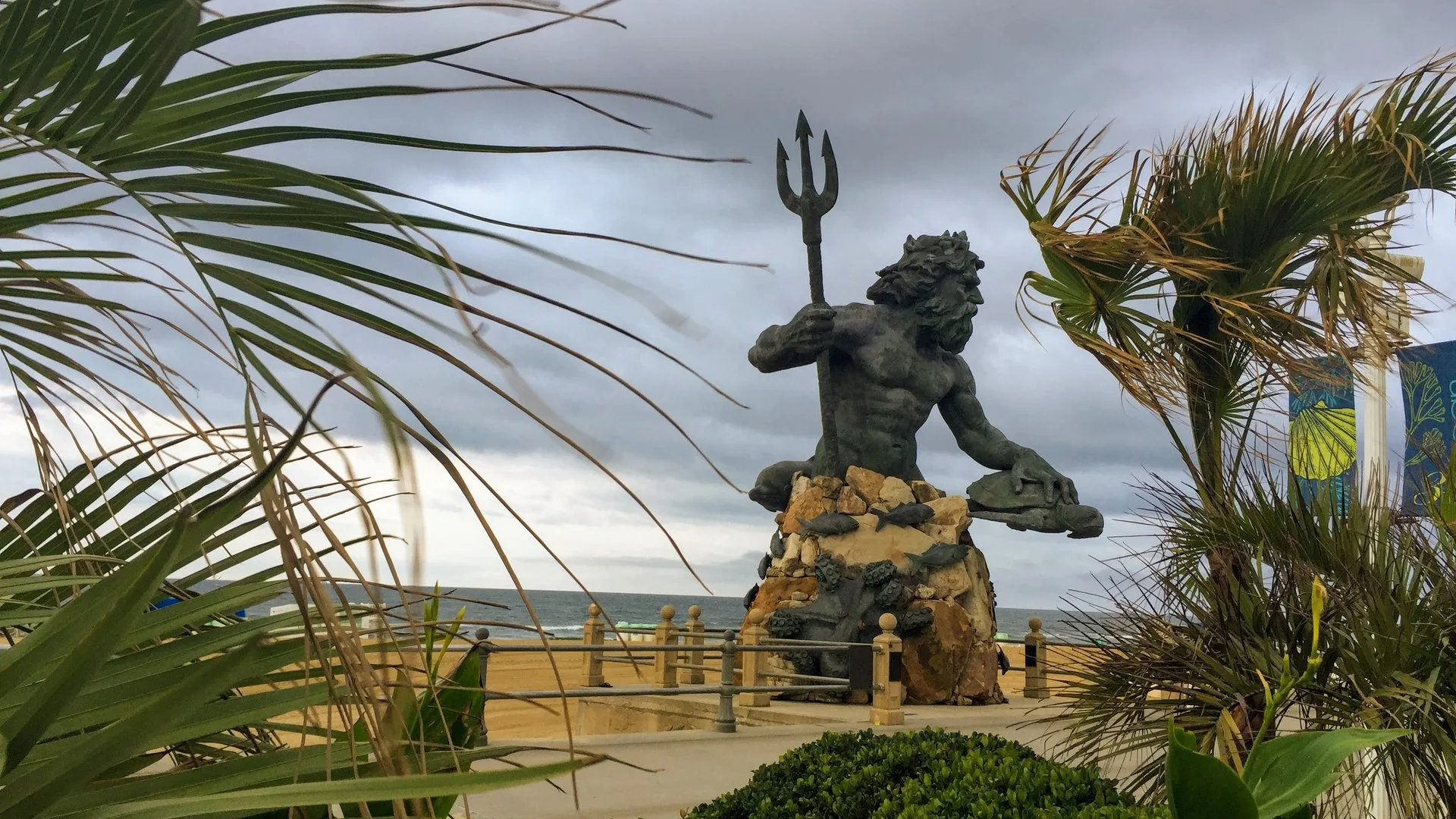 The King Neptune statue on the Virginia Beach boardwalk with the Atlantic Ocean in the background